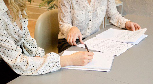 two women doing paper work